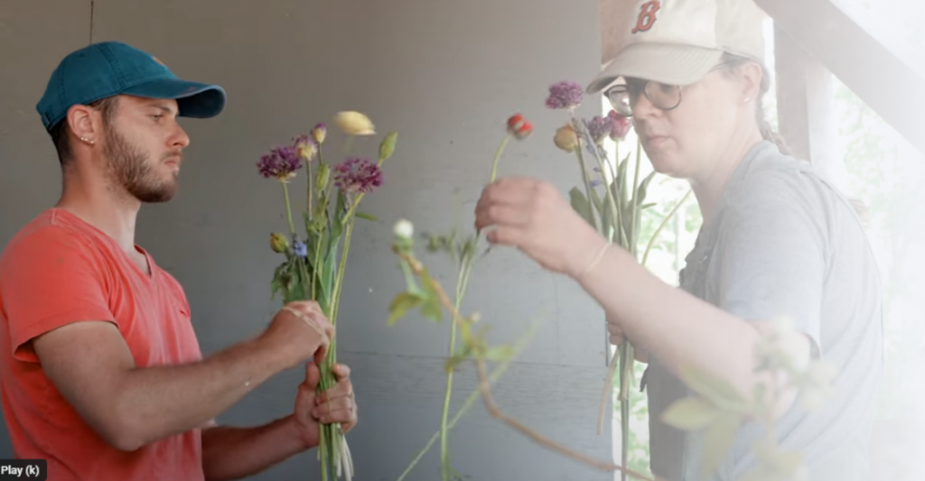 man and woman sorting cut flowers