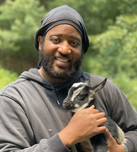 Freedom Gerardo holding a baby goat
