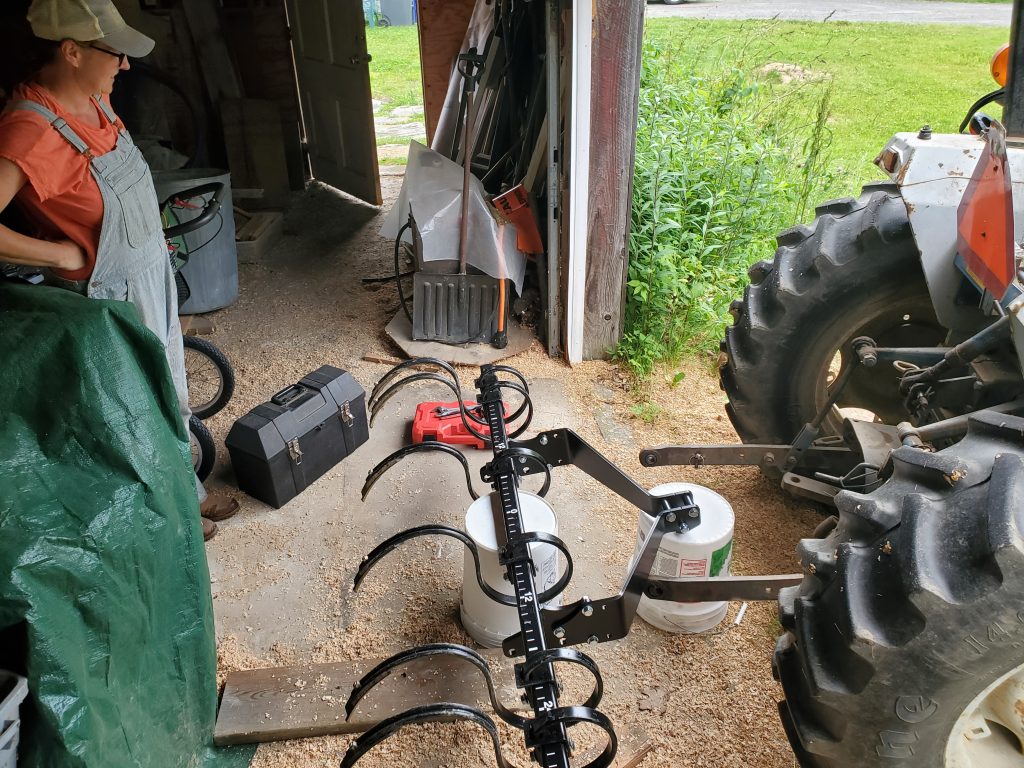 Tractor with tines implement attached