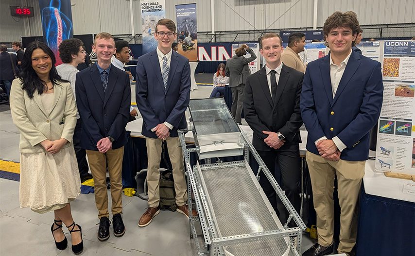Students stand around corn kernel cleaner built for Sepe Farm.